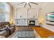 Elegant living room featuring a fireplace, built-in shelving, and high ceilings, creating a sophisticated ambiance at 2818 Mossy Timber Trl, Valrico, FL 33596