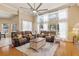 Spacious living room with high ceilings, two sofas, and a beautiful view of the outdoors through large windows at 2818 Mossy Timber Trl, Valrico, FL 33596
