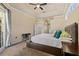 Cozy main bedroom with a tray ceiling, a ceiling fan, carpet, and glass doors leading to the outside at 2818 Mossy Timber Trl, Valrico, FL 33596