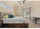 Comfortable main bedroom featuring a bed with upholstered headboard, tray ceiling, and glass doors to pool at 2818 Mossy Timber Trl, Valrico, FL 33596