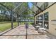 Covered patio with chairs and a fire pit overlooking the yard at 2818 Mossy Timber Trl, Valrico, FL 33596