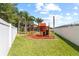 Playground with swing and slide set alongside fenced perimeter at 2818 Mossy Timber Trl, Valrico, FL 33596
