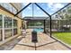 Beautiful pool area with screened enclosure, brick patio, and poolside seating perfect for entertaining at 2818 Mossy Timber Trl, Valrico, FL 33596
