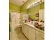 Bright bathroom featuring neutral walls, tile floors, shower with tub, and large vanity with ample counter space at 30442 Lettingwell Cir, Wesley Chapel, FL 33543