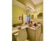 Bathroom with a mirrored vanity, bright lighting, and a view into an adjacent room at 30442 Lettingwell Cir, Wesley Chapel, FL 33543