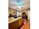 Comfortable bedroom with ceiling fan, warm brown walls, and dark wood floors at 30442 Lettingwell Cir, Wesley Chapel, FL 33543