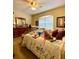 Bedroom with a ceiling fan, one window and furniture including bed and dresser at 30442 Lettingwell Cir, Wesley Chapel, FL 33543
