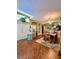 Open-concept floor plan with dining area featuring wood floors and natural light at 30442 Lettingwell Cir, Wesley Chapel, FL 33543