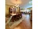 Spacious dining area leading to living room, featuring elegant chandelier and stylish hardwood floors at 30442 Lettingwell Cir, Wesley Chapel, FL 33543