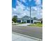 Charming exterior of a blue townhouse with well-manicured landscaping and a two-car garage at 30442 Lettingwell Cir, Wesley Chapel, FL 33543