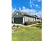 View of the home's front exterior highlighting the gray paint, dark garage, and landscaping at 30442 Lettingwell Cir, Wesley Chapel, FL 33543