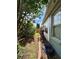 Exterior side yard with a side view of the home and beautiful landscaping at 30442 Lettingwell Cir, Wesley Chapel, FL 33543