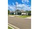 A blue townhouse featuring a large two-car garage and well-kept landscaping at 30442 Lettingwell Cir, Wesley Chapel, FL 33543