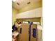Convenient laundry room featuring white cabinets and modern appliances for efficient chores at 30442 Lettingwell Cir, Wesley Chapel, FL 33543