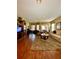 Bright living room featuring hardwood floors, ceiling fan, and inviting living space at 30442 Lettingwell Cir, Wesley Chapel, FL 33543