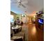 A spacious living room with wood flooring and warm lighting leads into an open dining area at 30442 Lettingwell Cir, Wesley Chapel, FL 33543