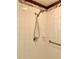 Bright shower with white tile, marble trim, and hand shower head and grab bar at 30442 Lettingwell Cir, Wesley Chapel, FL 33543
