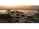 Aerial view of luxury waterfront home with meticulously landscaped grounds and private dock at 3310 Sunset N Dr, St Petersburg, FL 33710