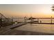 Backyard pool at dusk featuring a private dock, putting green, and stunning waterfront views at 3310 Sunset N Dr, St Petersburg, FL 33710
