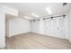Versatile bonus room with sliding barn doors and wood-look floors at 3310 Sunset N Dr, St Petersburg, FL 33710