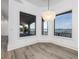 Bright dining room showcasing water views, wood floors, chandelier, and bay windows at 3310 Sunset N Dr, St Petersburg, FL 33710