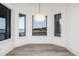 Bright dining room featuring water views, wood floors, chandelier, and bay windows at 3310 Sunset N Dr, St Petersburg, FL 33710