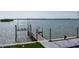 A waterfront view of the dock with a boat lift extending into the tranquil water at 3310 Sunset N Dr, St Petersburg, FL 33710