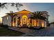 Stunning waterfront home showcasing elegant architectural design and lush landscaping at sunset at 3310 Sunset N Dr, St Petersburg, FL 33710