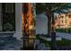 Dramatic torchlight highlights stylish black front door with glass and metal framing at 3310 Sunset N Dr, St Petersburg, FL 33710