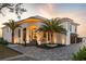 Elegant home featuring a well-manicured lawn, palm trees, and stylish pavers leading to the grand entrance at 3310 Sunset N Dr, St Petersburg, FL 33710