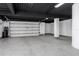 Spacious three car garage with speckled epoxy floors, finished white walls, and updated lighting at 3310 Sunset N Dr, St Petersburg, FL 33710