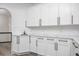 Modern kitchen with white cabinets, marble countertop, and subway tile backsplash at 3310 Sunset N Dr, St Petersburg, FL 33710