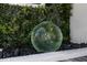 Stylish green glass ball nestled amidst greenery and decorative stone landscaping at 3310 Sunset N Dr, St Petersburg, FL 33710