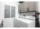 This laundry room has a white washer and dryer with gray cabinets at 3310 Sunset N Dr, St Petersburg, FL 33710