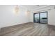 Spacious living room featuring tray ceilings, water views, wood floors, and a balcony at 3310 Sunset N Dr, St Petersburg, FL 33710