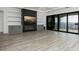 Living room with built-in shelving, fireplace, and a large glass sliding door to a patio with a water view at 3310 Sunset N Dr, St Petersburg, FL 33710