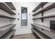 Spacious walk-in pantry with custom shelving and water views at 3310 Sunset N Dr, St Petersburg, FL 33710