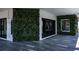 Outdoor patio featuring a living green wall, electric vehicle charger, and tiled floors at 3310 Sunset N Dr, St Petersburg, FL 33710