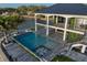 Stunning waterfront property featuring a pool, spa, covered patio, and lush landscaping at 3310 Sunset N Dr, St Petersburg, FL 33710