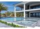 Gorgeous home featuring a sparkling pool and jacuzzi set against a beautiful waterfront backdrop with blue skies at 3310 Sunset N Dr, St Petersburg, FL 33710