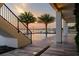 Scenic sunset view of the backyard pool and waterfront with swaying palm trees at 3310 Sunset N Dr, St Petersburg, FL 33710