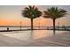 Inviting pool with built-in jacuzzi and serene water view, framed by swaying palm trees and modern lighting fixtures at 3310 Sunset N Dr, St Petersburg, FL 33710