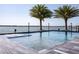Stunning waterfront pool with clear blue water and tropical palm trees at 3310 Sunset N Dr, St Petersburg, FL 33710
