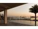 A luxury pool with views of the sunset, a palm tree, and a private boat dock at 3310 Sunset N Dr, St Petersburg, FL 33710