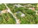 Aerial shot of a home with pool and metal outbuilding surrounded by trees at 5404 Carso Ter, North Port, FL 34286