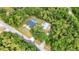 A bird's eye view of a home with an in-ground pool, metal workshop, and large backyard at 5404 Carso Ter, North Port, FL 34286