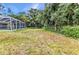 Sprawling backyard with a screened in pool offers ample space for outdoor enjoyment at 5404 Carso Ter, North Port, FL 34286