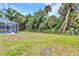 A spacious backyard features a pool and lush greenery at 5404 Carso Ter, North Port, FL 34286