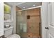 Bathroom features a shower with sliding glass doors and tan tiling at 5404 Carso Ter, North Port, FL 34286