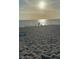 Scenic beach view with sunlit water, sandy shoreline, and a serene coastal atmosphere at 5404 Carso Ter, North Port, FL 34286